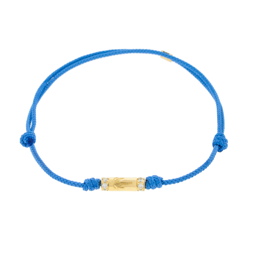 LUIS MORAIS 14K yellow gold slim tube with a palm tree symbol and two channels of white diamonds on a blue cord bracelet 
