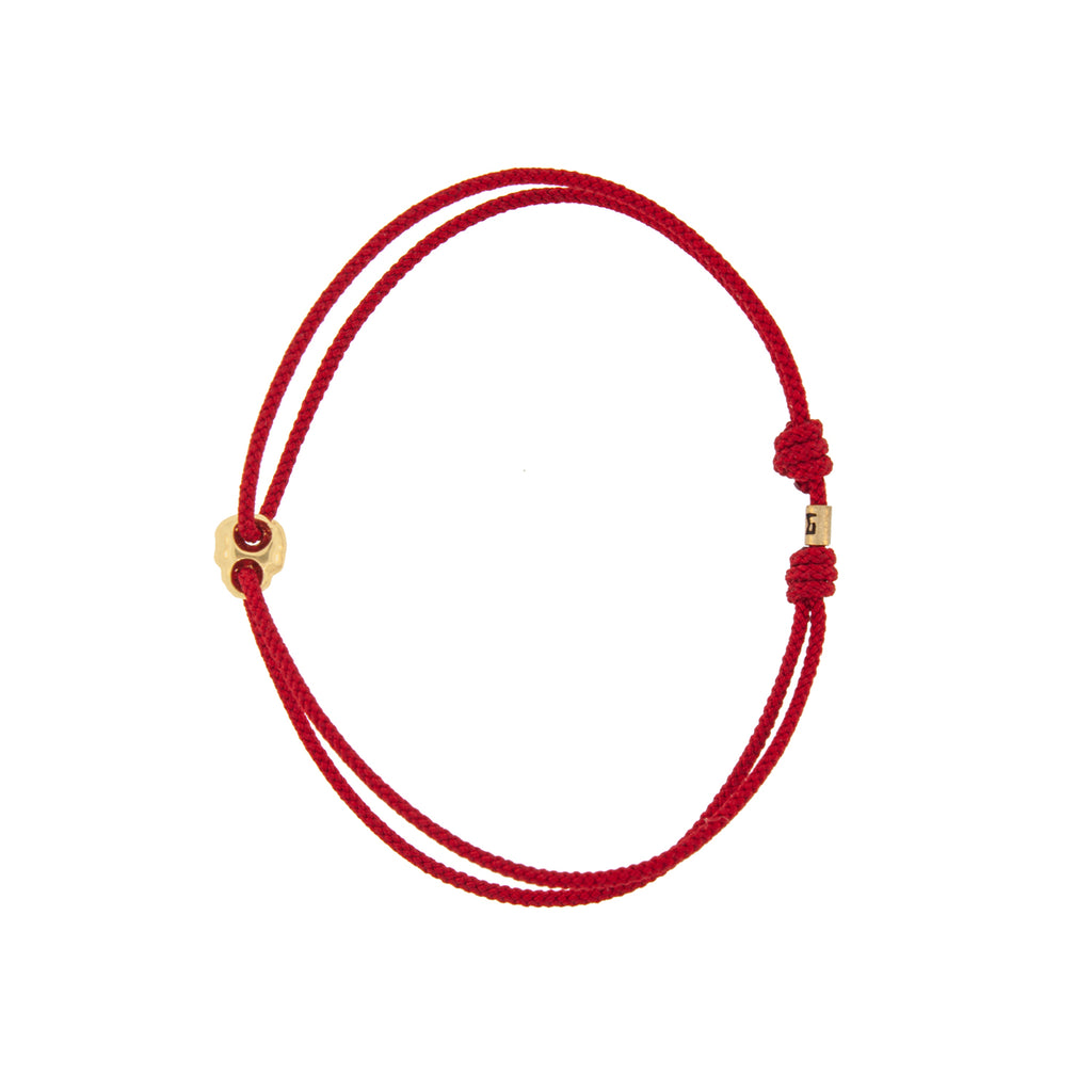 Yellow Gold Small Skull Outline on a Red Cord Bracelet