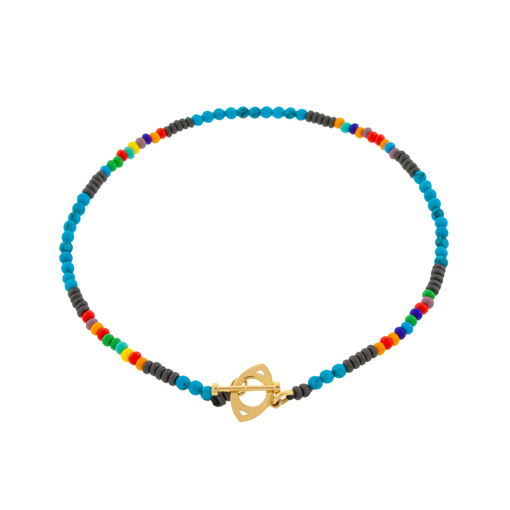 LUIS MORAIS 14K yellow gold evil eye toggle clasp on a turquoise, hematite and glass beaded bracelet