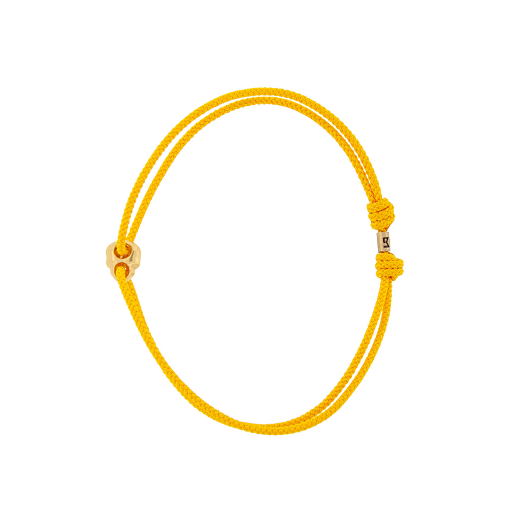 Yellow Gold Small Skull Outline on a Yellow Cord Bracelet